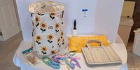Front view showing tote, dust bag, hamper, hangers, lint roller, gloves