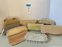All nine clutches grouped to show variety of sizes, styles and materials