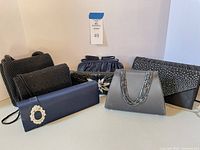 All seven handbags grouped to show variety of styles, colors and embellishments