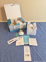 Camera, adapter, screws, manuals and box laid out