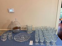 All items on table: pitcher, goblets, tumblers, bowls, serving plate, covered egg holder