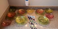 Full set of glass plates, bowls and iridescent flatware laid out