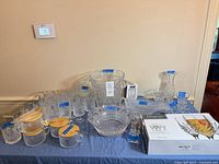 Overview of lot on table showing variety of glass and crystal pieces