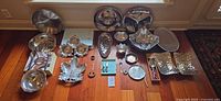 Group shot of all silver-tone serveware and utensils laid out