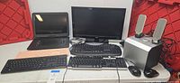 Entire lot showing TV, portable DVD player, three keyboards, two mice, speakers, subwoofer