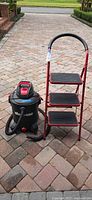 Vacuum and stool full view on driveway