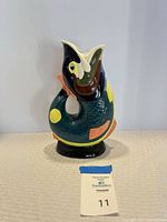 Front view of multicolor fish pitcher showing full design and glossy glaze