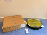 Box and stacked charger plates on table