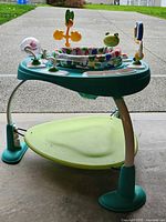 Full view of activity center showing frame, seat and toys