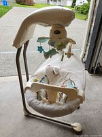 Full view of Fisher-Price cradle swing showing frame, seat and mobile