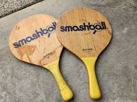 Two Smashball paddles front view showing logos and handle condition