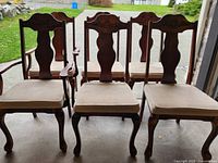 Front view of all six carved wood dining chairs