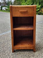 Front view showing drawer and two shelves