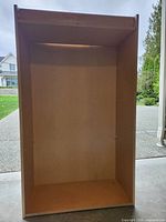 Front view of empty bookcase showing interior and missing shelves