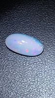 Full view of oval opal showing play of color