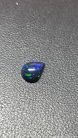 Front view of pear cabochon opal showing blue and green flashes