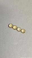 Four round golden citrine gemstones on neutral background