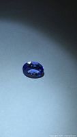 Top view of oval faceted blue gemstone