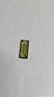 Front view of baguette-cut green tourmaline on neutral background