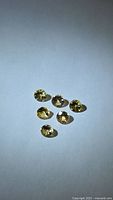six round champagne yellow gemstones on white background