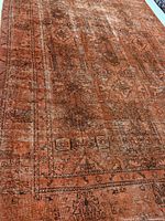 Full view of entire rug showing size, color, and overall wear