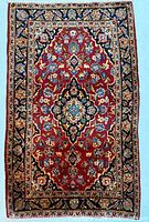 Full view of Kashan rug showing overall design and borders