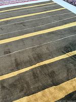 Full view of rug showing dark olive field and light brown stripes