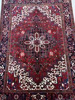 Full view of Persian Heriz rug showing entire design and borders