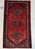 Full view of Persian rug showing design and condition