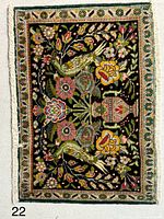 Full view of Tabriz rug showing bird and floral pictorial design, fringe visible