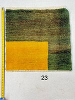 Full view of square Gabeh rug beside measuring tape