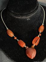 Front view of Coralium bead necklace on display bust