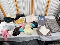 Tabletop view of assorted fabrics and baby clothing pieces