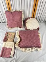 Overview of two square pillows, one round pillow, two folded covers