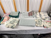 Assorted folded fabrics laid out on table
