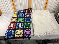 Full view of both blankets side by side, showing sizes and textures
