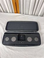 Speaker dock in open zip travel case