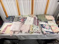 Full view of all folded bedding and curtain pieces on table