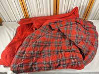 Full view of blanket showing plaid front and solid reverse