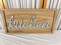 Front view of rectangular wood sign with galvanized metal script