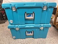 Two blue Sterilite containers stacked, front view showing latches and handles