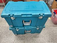 Two stacked blue Sterilite rolling storage trunks, top and front view