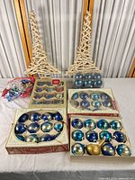 Full lot showing driftwood trees, four boxes of ornaments and gift bows