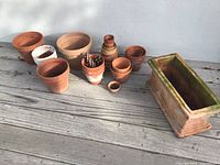 All pots grouped on deck, showing sizes and finishes