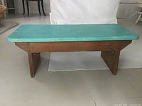 Side view of pine stool bench showing turquoise top and brown base