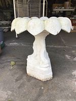 Front view of assembled birdbath showing petalled bowl and dolphin pedestal