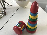 Stacking toy assembled beside rolling bell rattle
