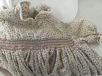 Close-up of floral smocked dress front detailing