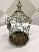 Full view of pagoda bird cage with feeder attached
