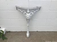 Full view of cast iron leg against wall